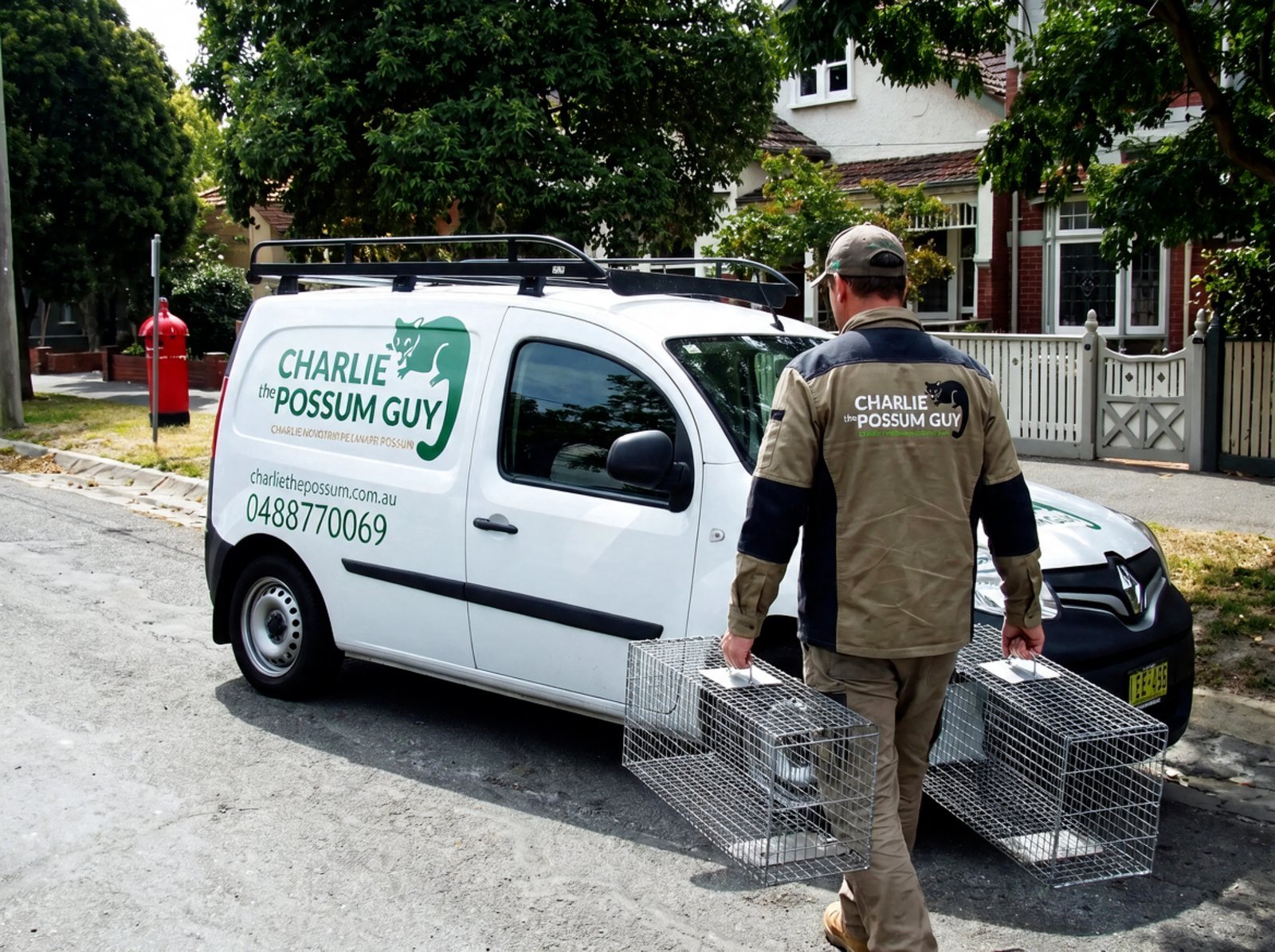 Charlie the Possum Guy branded van and humane possum traps in a Melbourne street